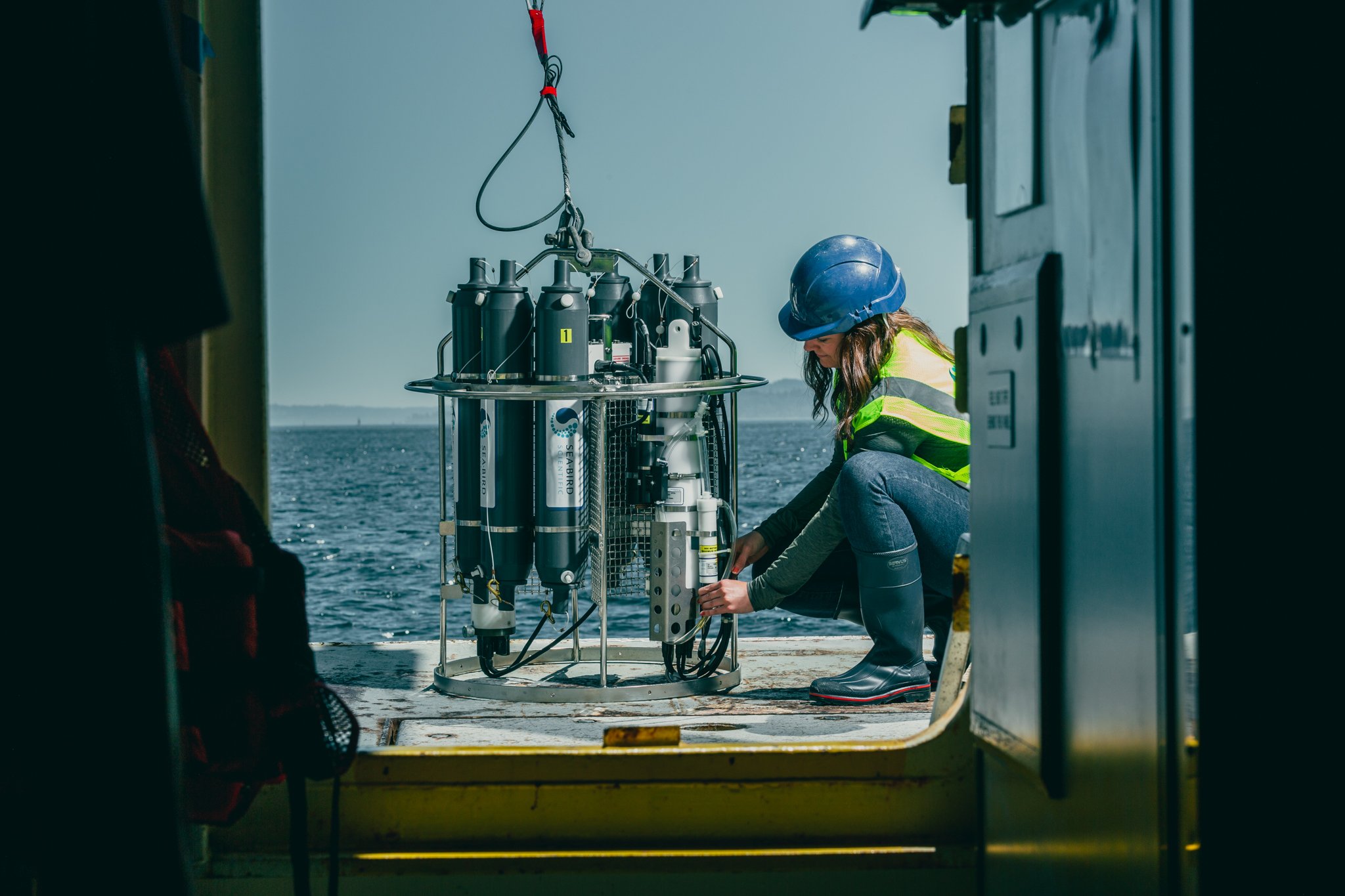 Oceanographer adjusting settings on the SBE 911plus water sampler, carousel, rosette for ocean profiling
