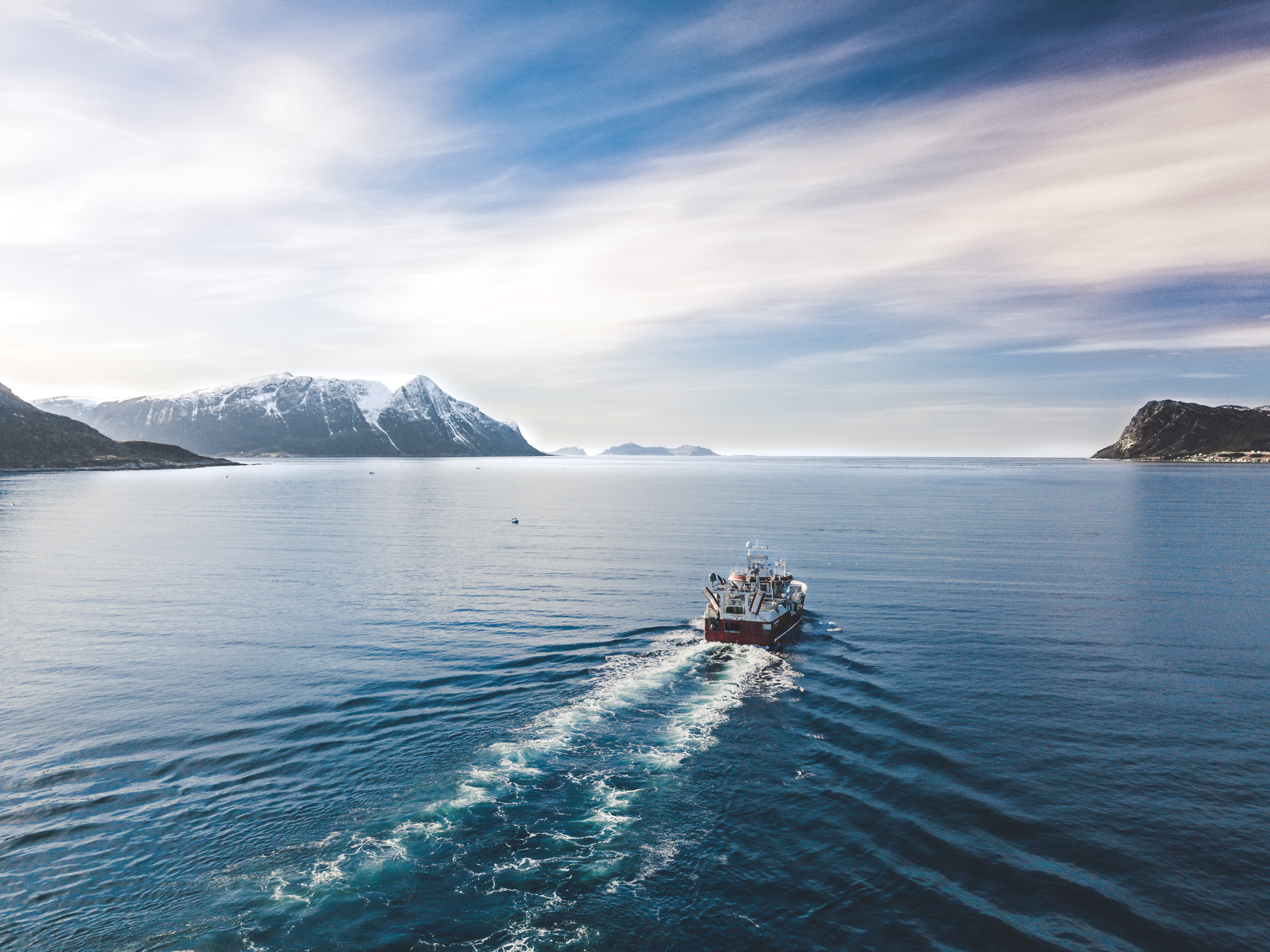 Boat gliding across the open ocean