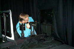 Technician calibrating a radiometer in a dark room with a specifically designed rig
