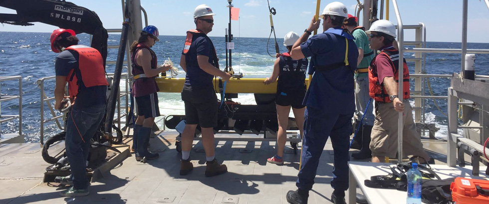 Scientists on the Gulf Explorer in the Gulf of Mexico measuring freshwater 